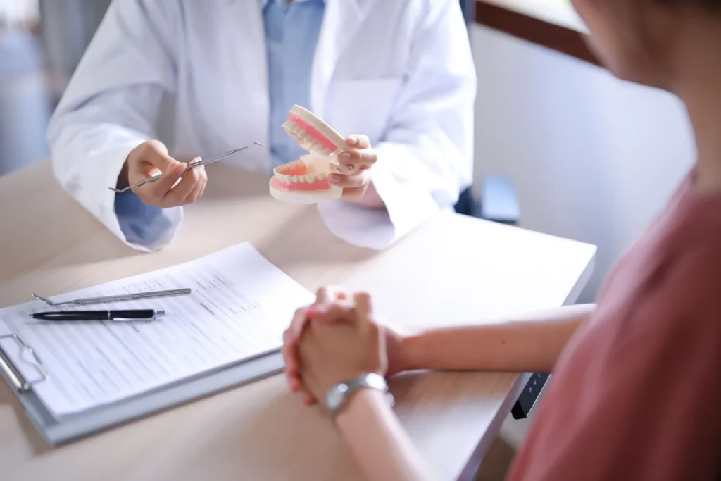 Pediodontist showing examples of complete dentures to patient